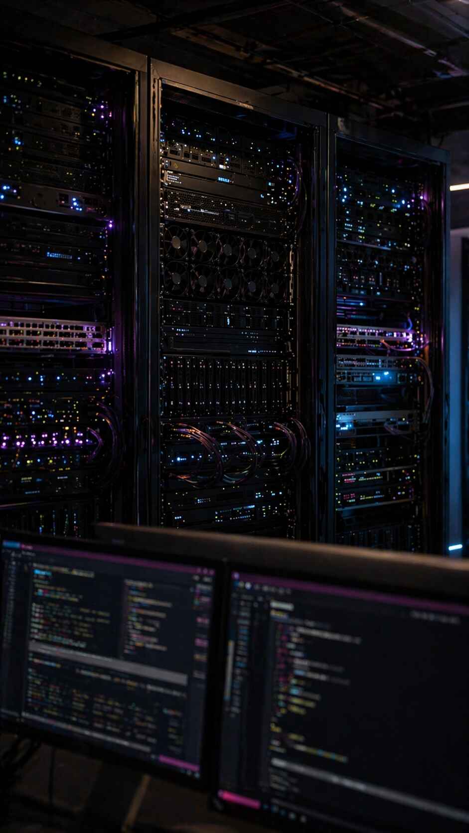 The Lucid server racks, violet and blue LEDs, code on the monitors in front
